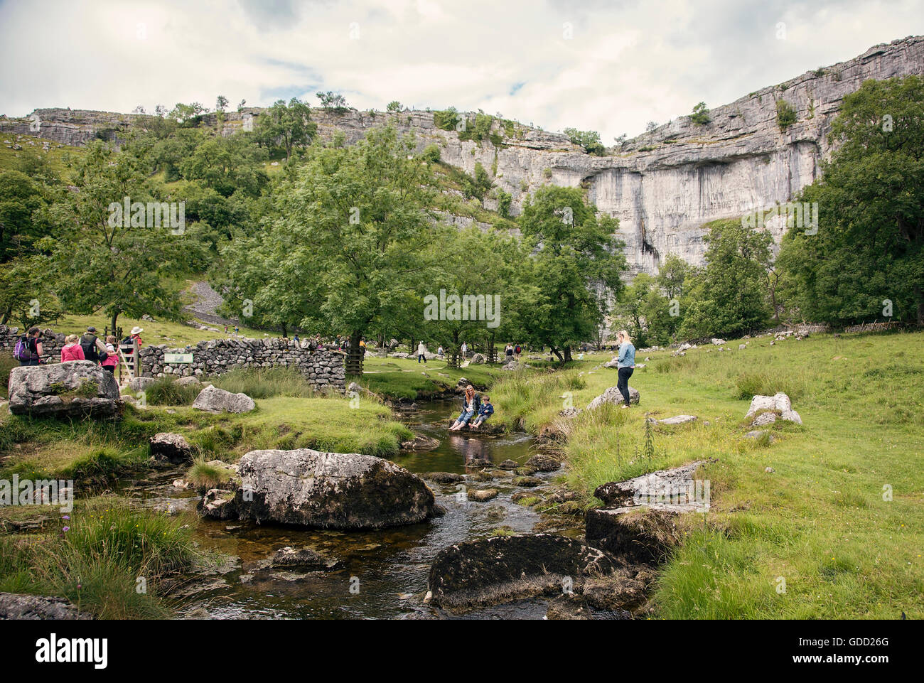 People and walkers by Malham beck and Malham Cove, Yorkshire Dales Stock Photo
