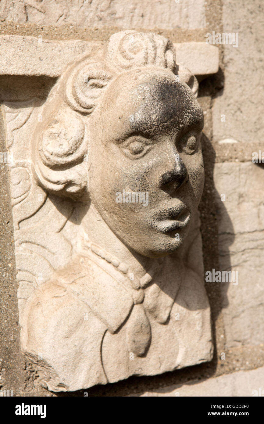 Ireland, Co Galway, Galway, Franciscan Abbey Church, exterior saint’s face above holy water stoup Stock Photo