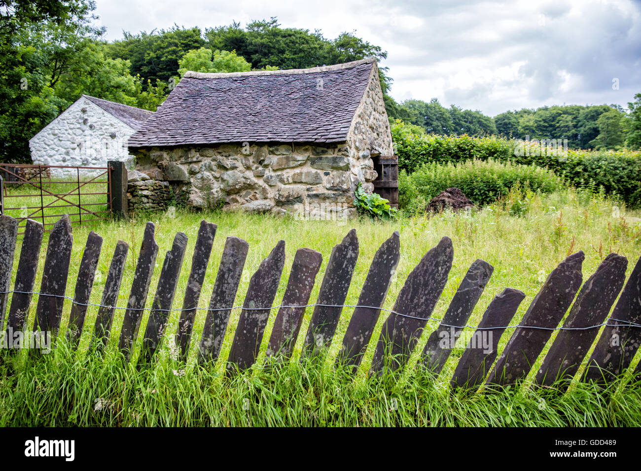 Reconstructed farm buildings and slate fence bordering a paddock at St Fagans National History Museum in Cardiff Wales UK Stock Photo