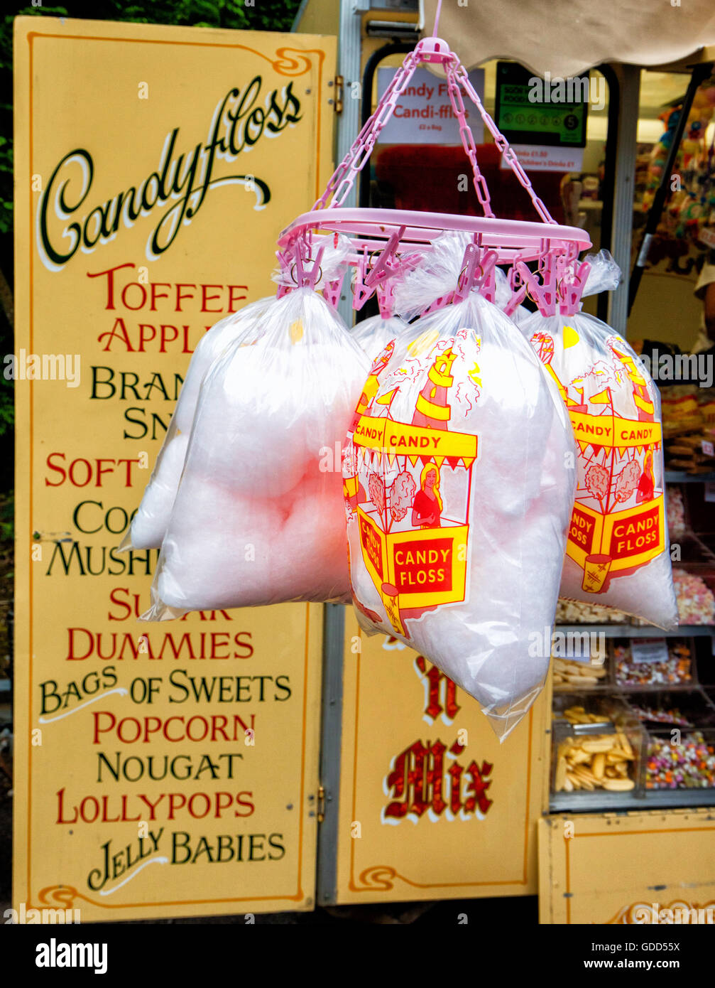 Candyfloss for sale in bags hanging in front of at an outside sweet shop in South Wales UK Stock Photo