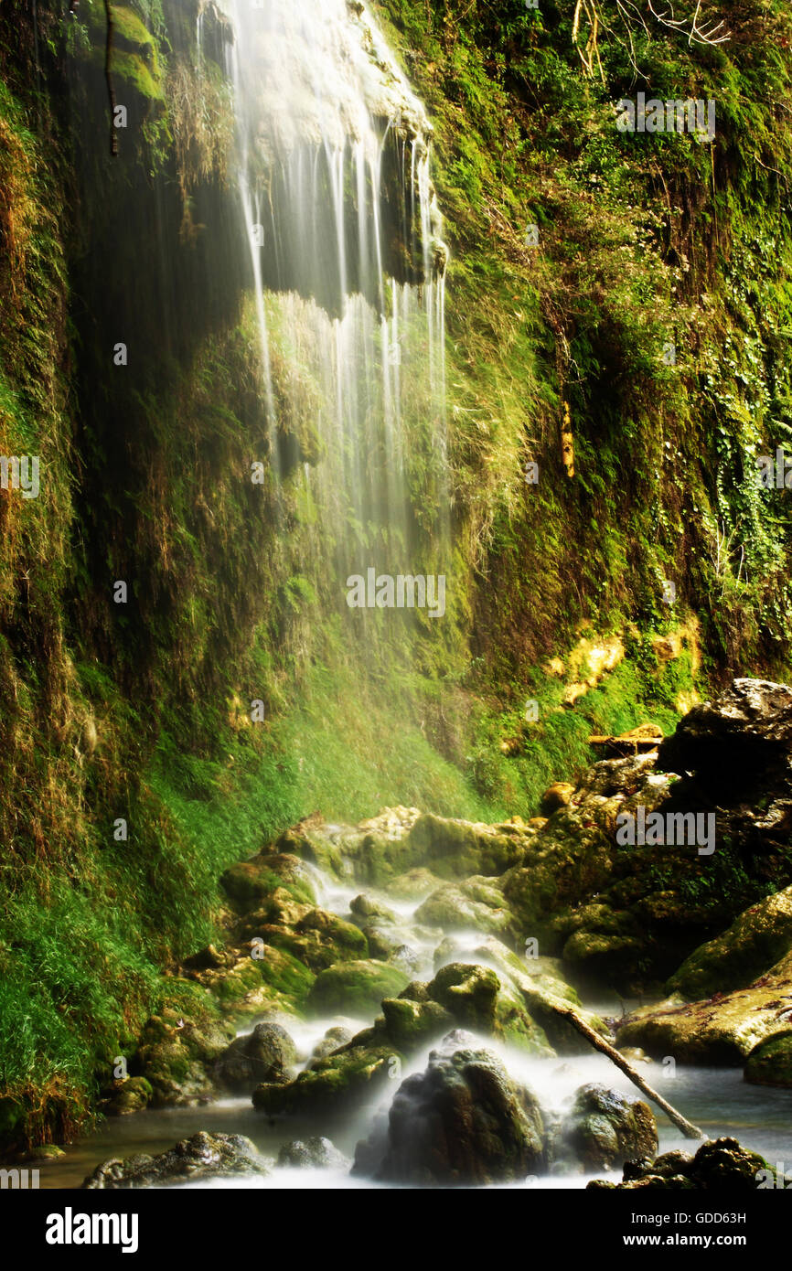 Blurred Stream Flowing Through Stones Stock Photo - Alamy