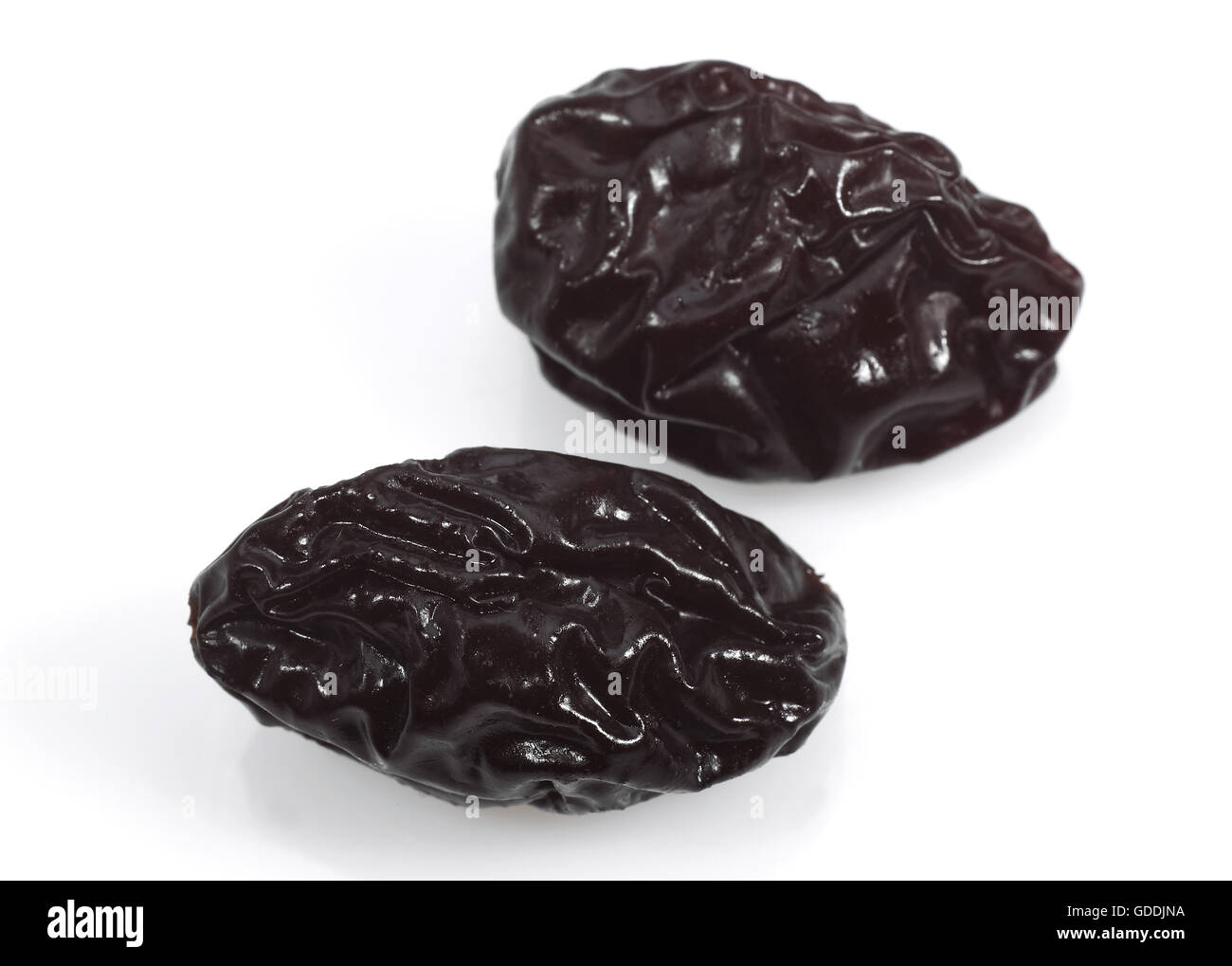 Dry Prunes against White Background Stock Photo