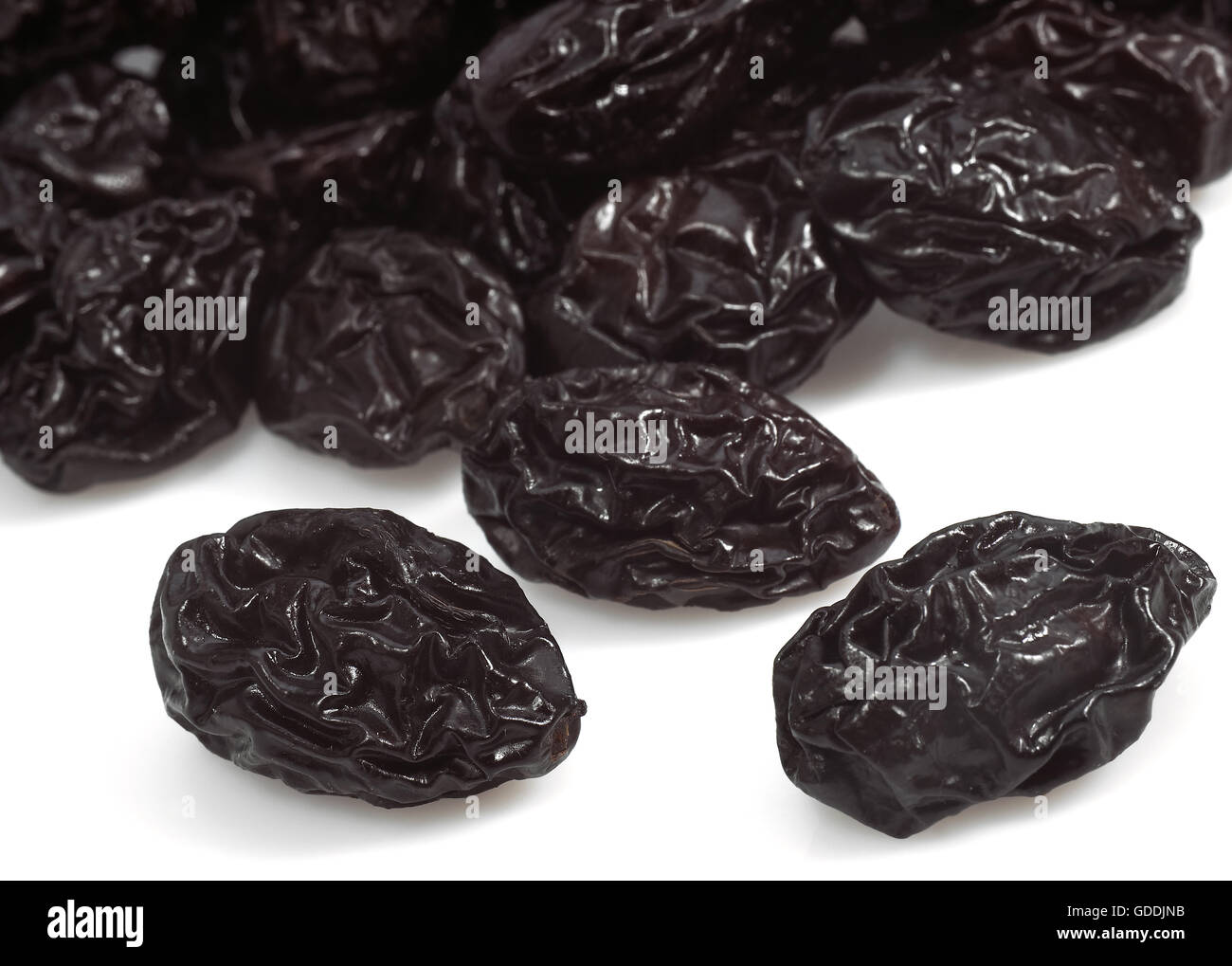 Dry Prunes against White Background Stock Photo