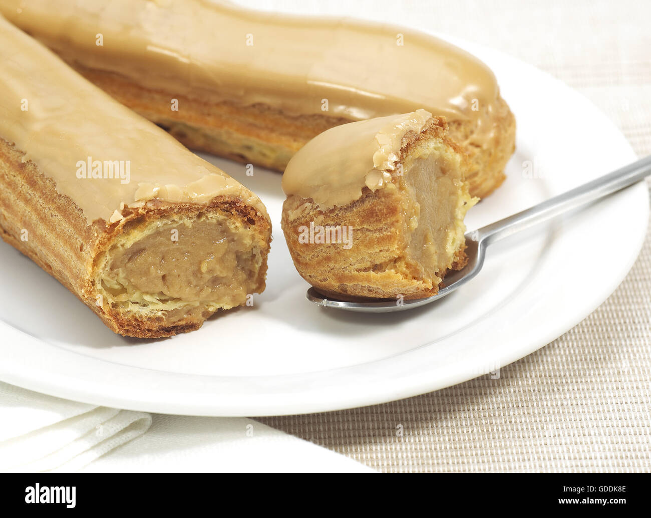 COFFEE ECLAIR ON A PLATE Stock Photo