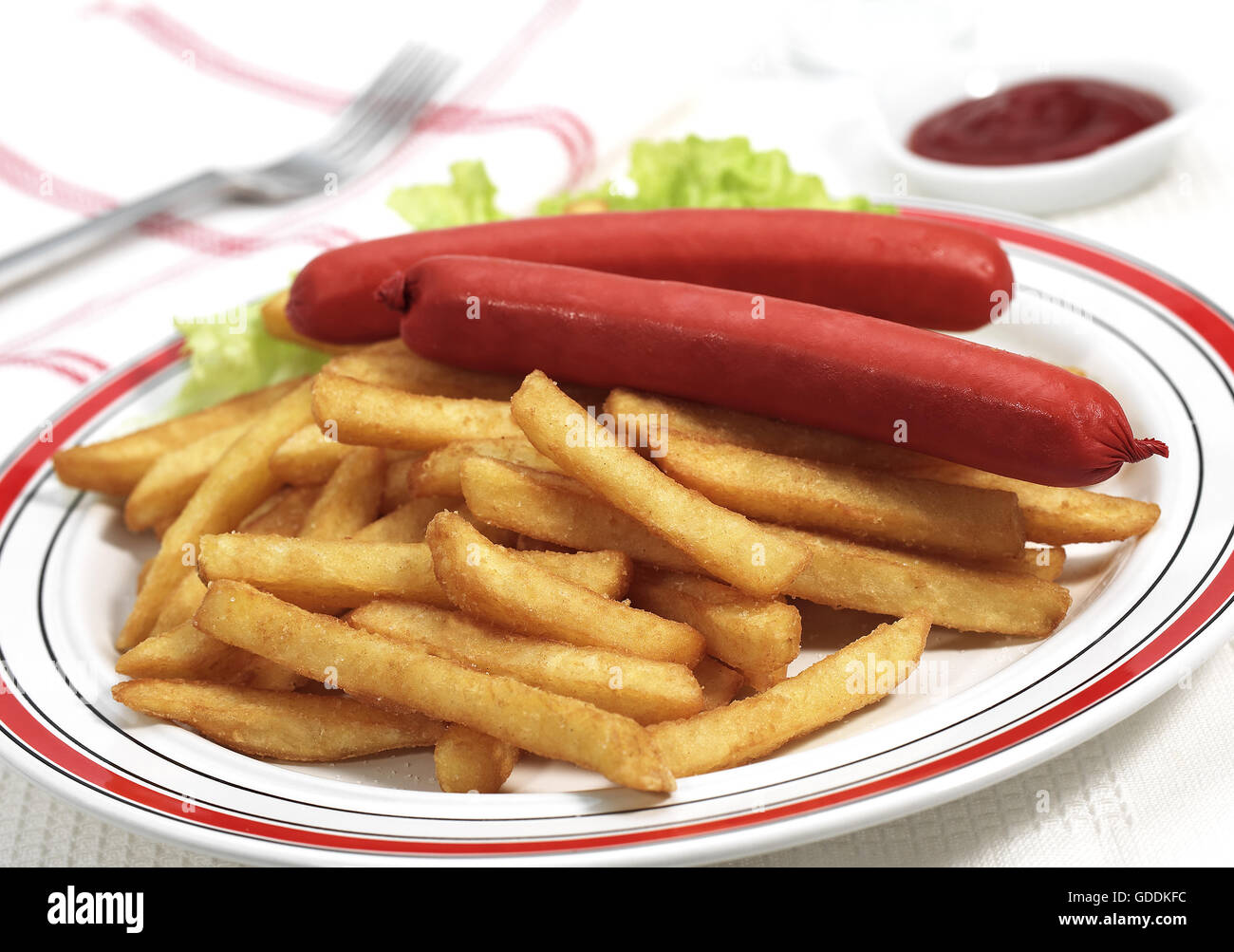 PLATE WITH SAUSAGES, FRENCH FRIES AND SALAD Stock Photo