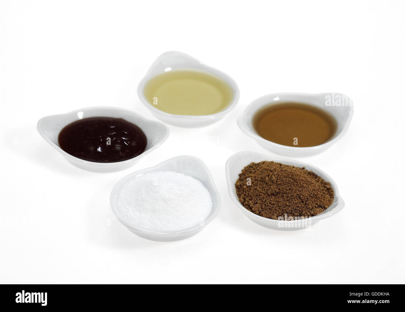 Fine Granulated Sugar, Brown Sugar, Maple Syrup, Treacle and Honey, Sugar against White Background Stock Photo