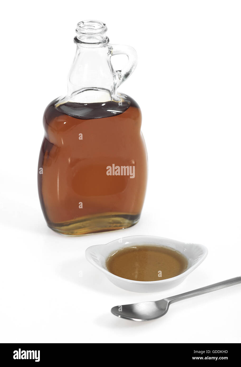 Bottle of Maple Syrup against White Background Stock Photo