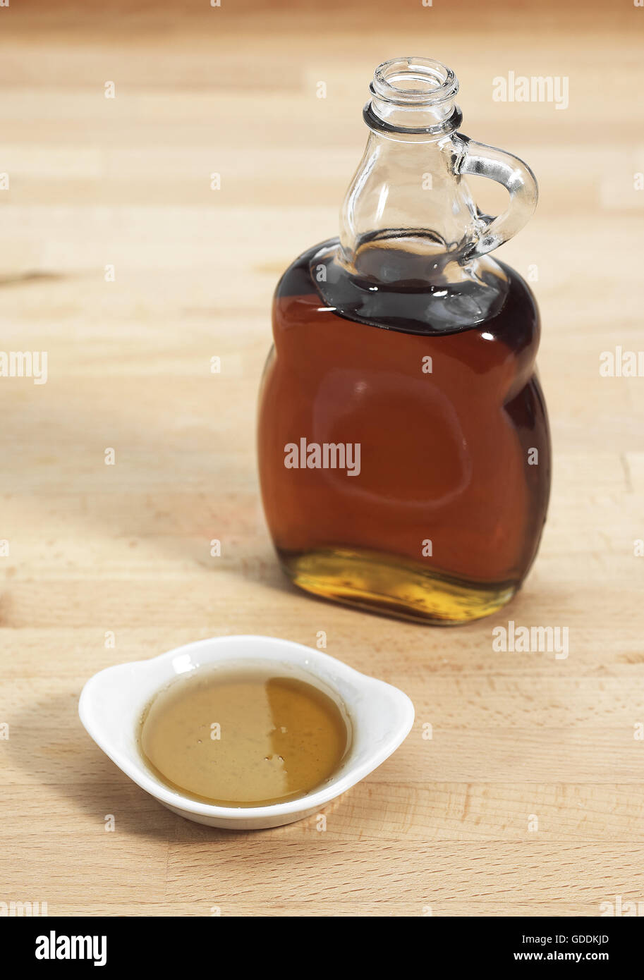 Bottle of Maple Syrup against White Background Stock Photo