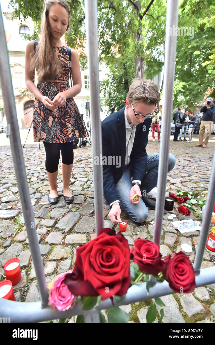 Prague, Czech Republic. 15th July, 2016. Czech people light a candle and lay flowers outside the French Embassy in Prague in tribute for the victims of the Nice attacks, in Prague, Czech Republic, 15 July 2016. According to reports, more than 80 people died and many were wounded. Credit:  Vit Simanek/CTK Photo/Alamy Live News Stock Photo