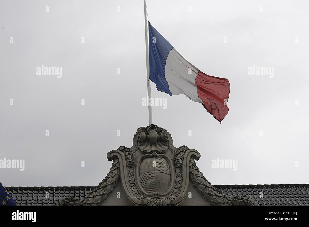 Copenhagen, Denmark. 16th July, 2016.-European union and French flags at half mast at french embassy and people are puring with flowers to pay tribute and stand solidatry with Frnech victims dies in terrorist attacked in Nice France on French national day on july 14, 2016 Credit:  Francis Joseph Dean/Dean Pictures/Alamy Live News Stock Photo