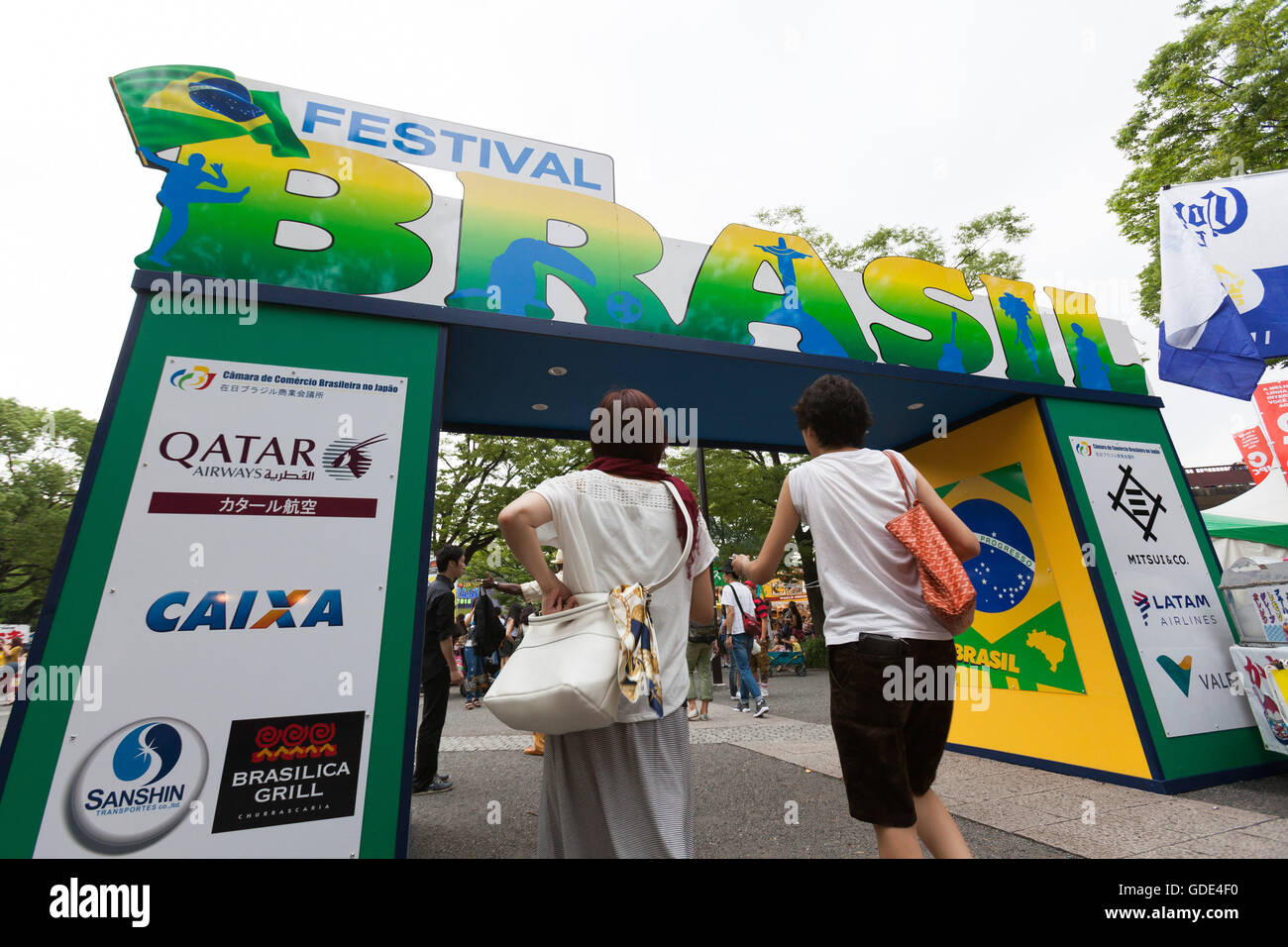 Tokyo, Japan. 16th July, 2016. Visitors enter to the Festival Brasil 2016 at Yoyogi Park on July 16, 2016, Tokyo, Japan. The annual festival brings together Brazilian food and entertainment including Samba and Capoeira performers. Organized by the Camara de Comercio Brasileira no Japao the event runs until July 17. The Brazilian community is the third largest immigrant population in Japan. Credit:  Rodrigo Reyes Marin/AFLO/Alamy Live News Stock Photo
