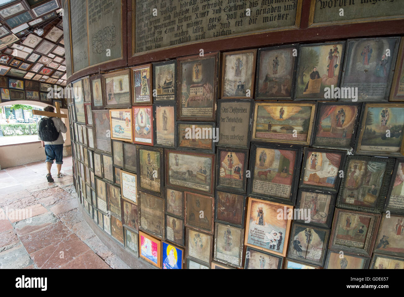 Altotting, Germany. 14th July, 2016. A man walks through the gallery around the chapel of grace in the pilgramage destination of Altotting, Germany, 14 July 2016. The gallery shows up tol 500-years-old paintings honouring the Mother of God. Photo: Armin Weigel/dpa/Alamy Live News Stock Photo