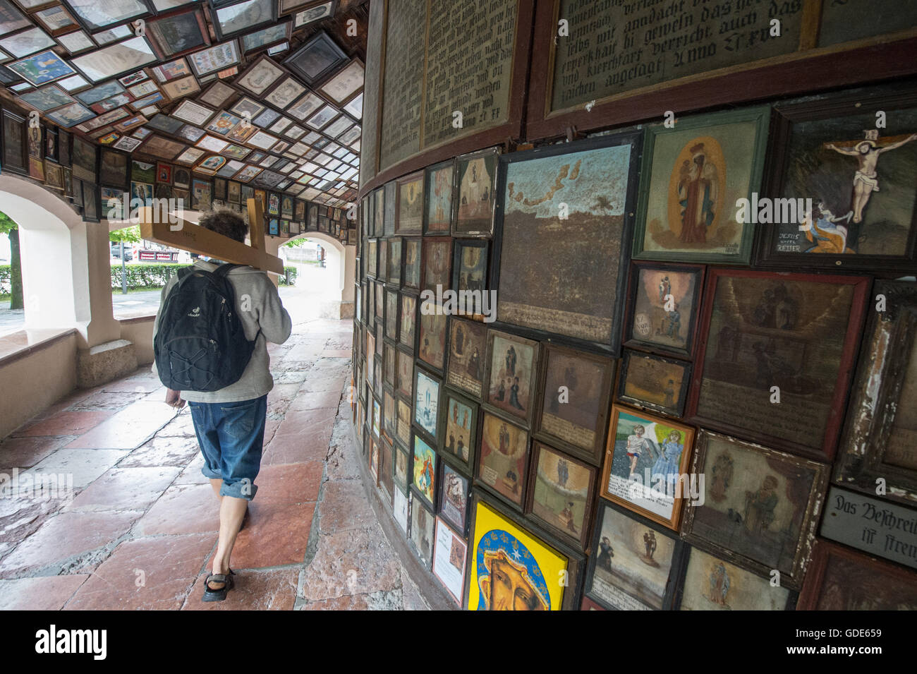 Altotting, Germany. 14th July, 2016. A man walks through the gallery around the chapel of grace in the pilgramage destination of Altotting, Germany, 14 July 2016. The gallery shows up tol 500-years-old paintings honouring the Mother of God. Photo: Armin Weigel/dpa/Alamy Live News Stock Photo