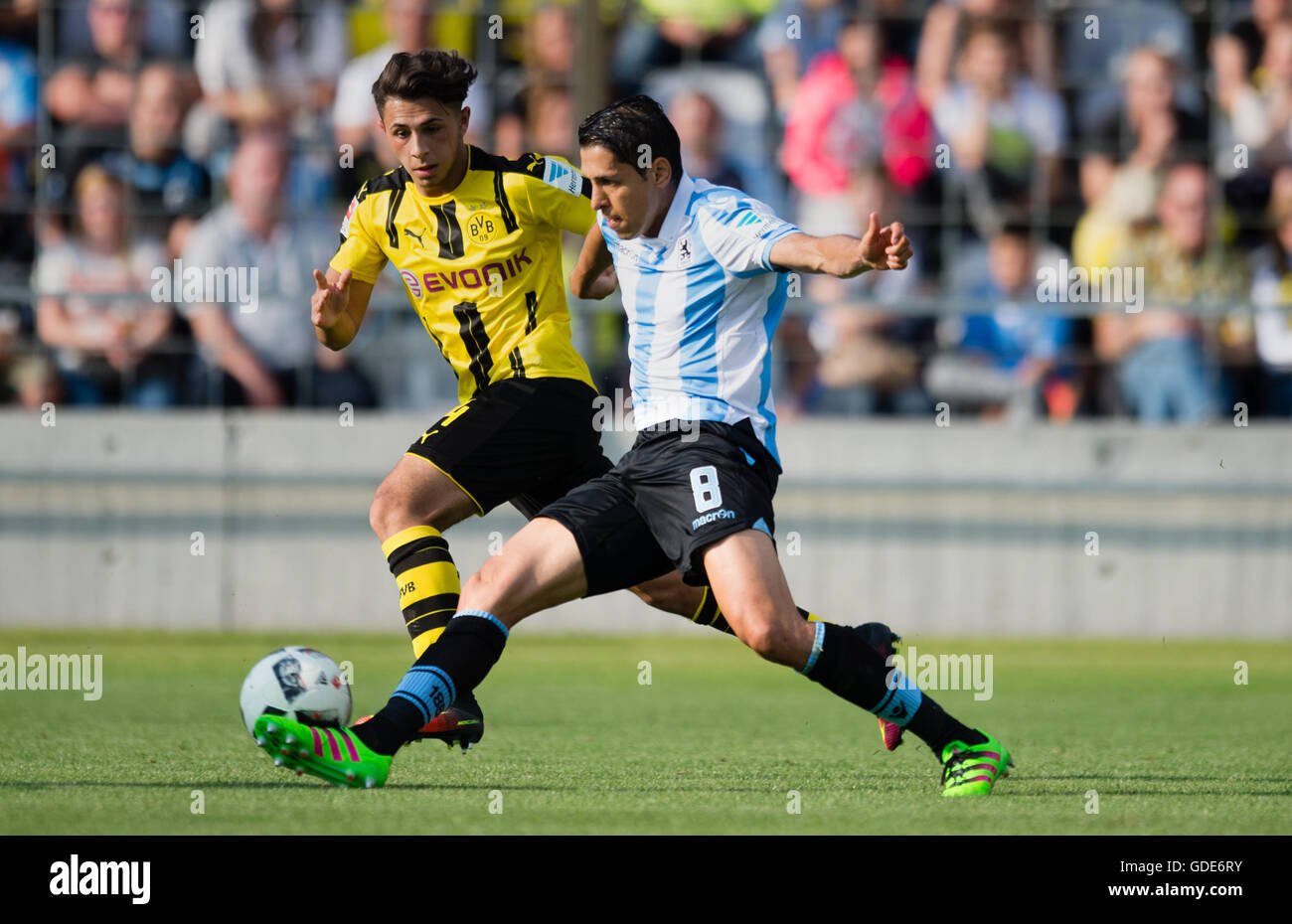 Munich, Germany. 16th July, 2016. Karim Matmour (r) of the second division team TSV 1960 Munich and Dario Scuderi (l) of premiere league team Borussia Dortmund fight for the ball in a test match between TSV 1860 Munich and Borussia Dortmund in the stadium at Grunswalder Strasse in Munich, Germany, 16 July 2016. Photo: Matthias Balk/dpa/Alamy Live News Stock Photo