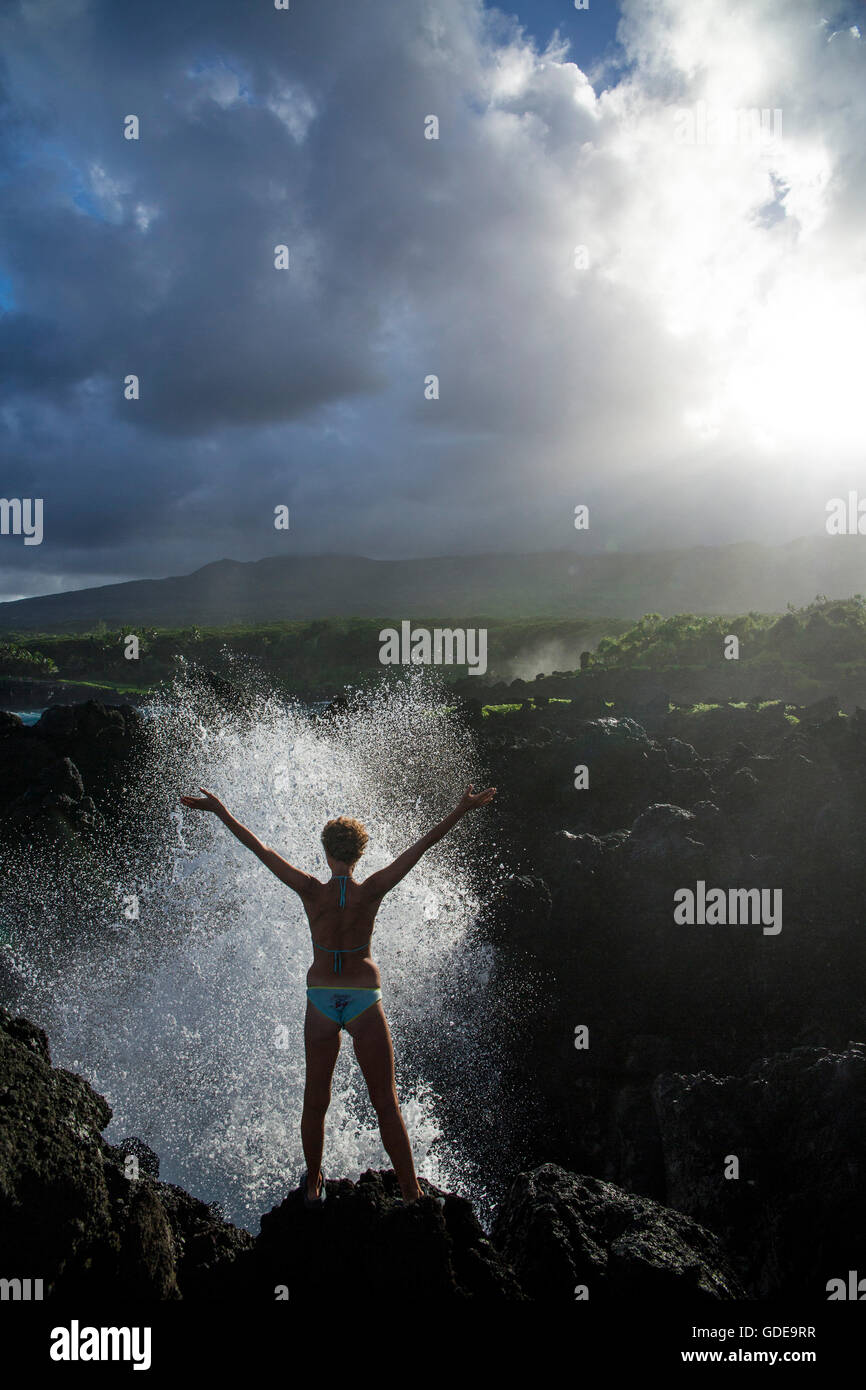 Maui,Wai'anapanapa,State park,coast,USA,Hawaii,America,rock,cliff,stone,mountains,woman,foam,surf,joy,stretch,wa Stock Photo