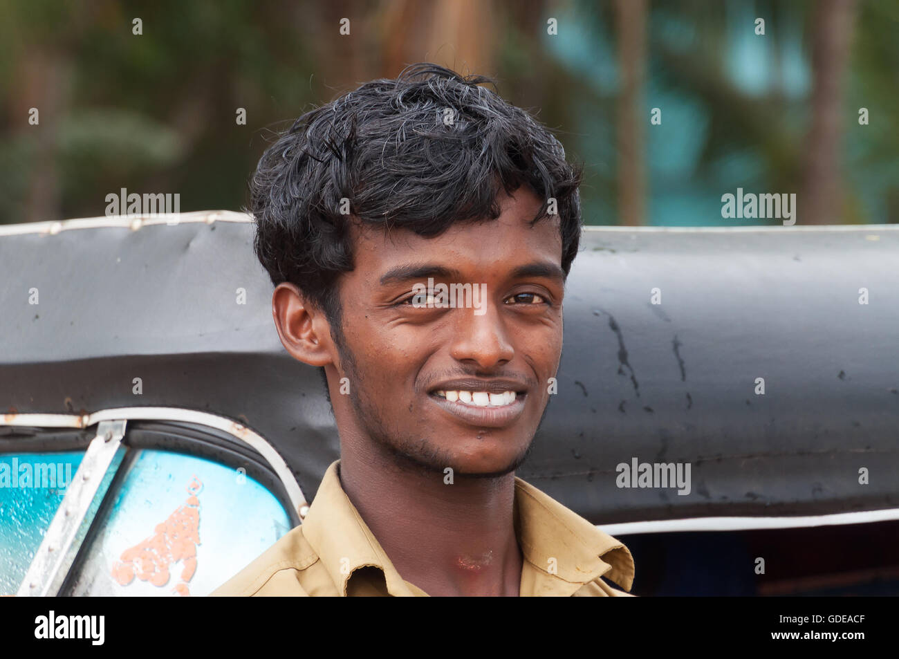Unidentified Indian taxi driver man of auto rickshaw in fishing village. Kovalam. Kerala. India Stock Photo