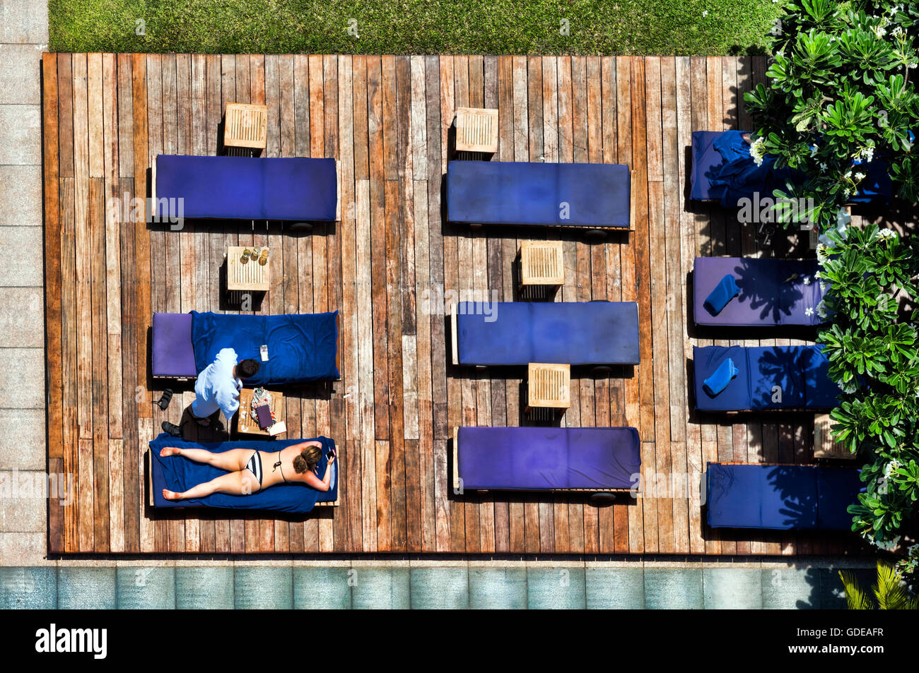 Guests sunbathing at a hotel swimming pool, Bangkok,Thailand Stock