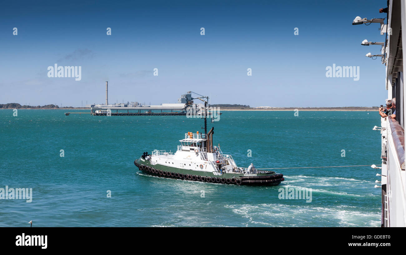 Bluff Harbour tug boat 'Hauroko' leading Le Soleal out of Bluff Harbour, New Zealand Stock Photo