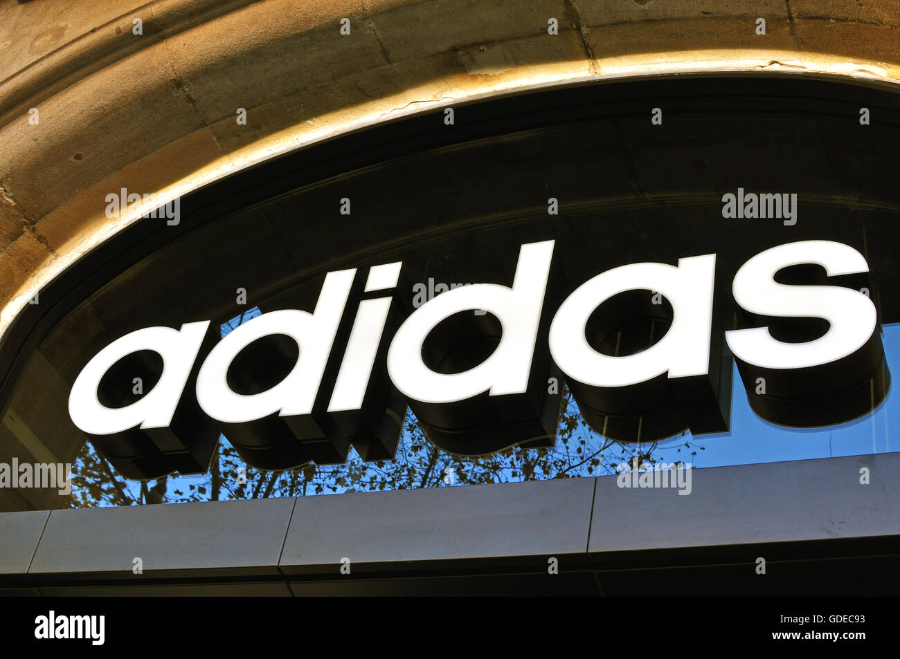 BARCELONA, SPAIN - DECEMBER 21: Logo of Adidas flagship store in the street of Barcelona on December 21, 2014. Stock Photo