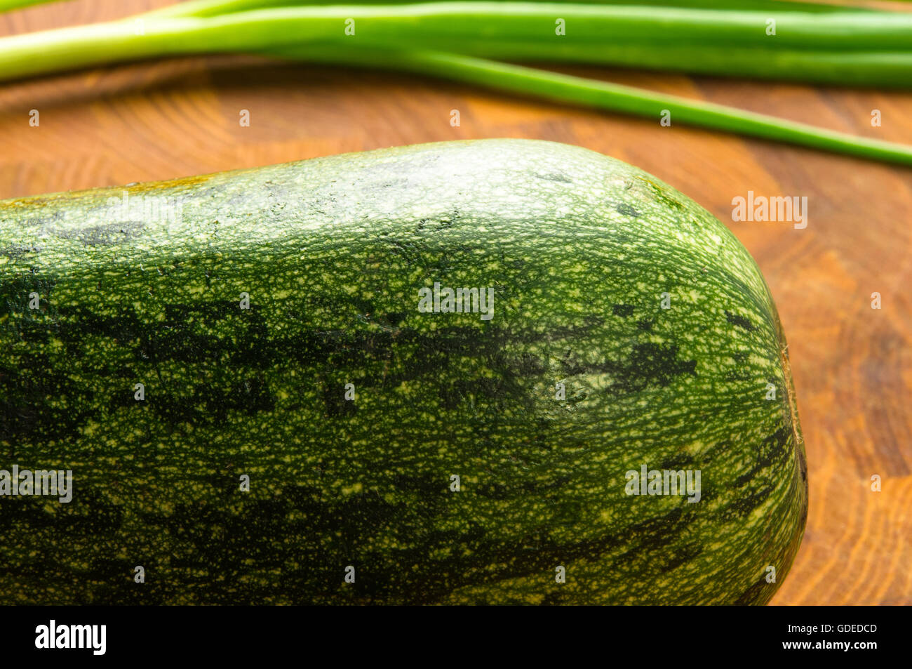 still life - zucchini and green onions on wooden Board Stock Photo - Alamy