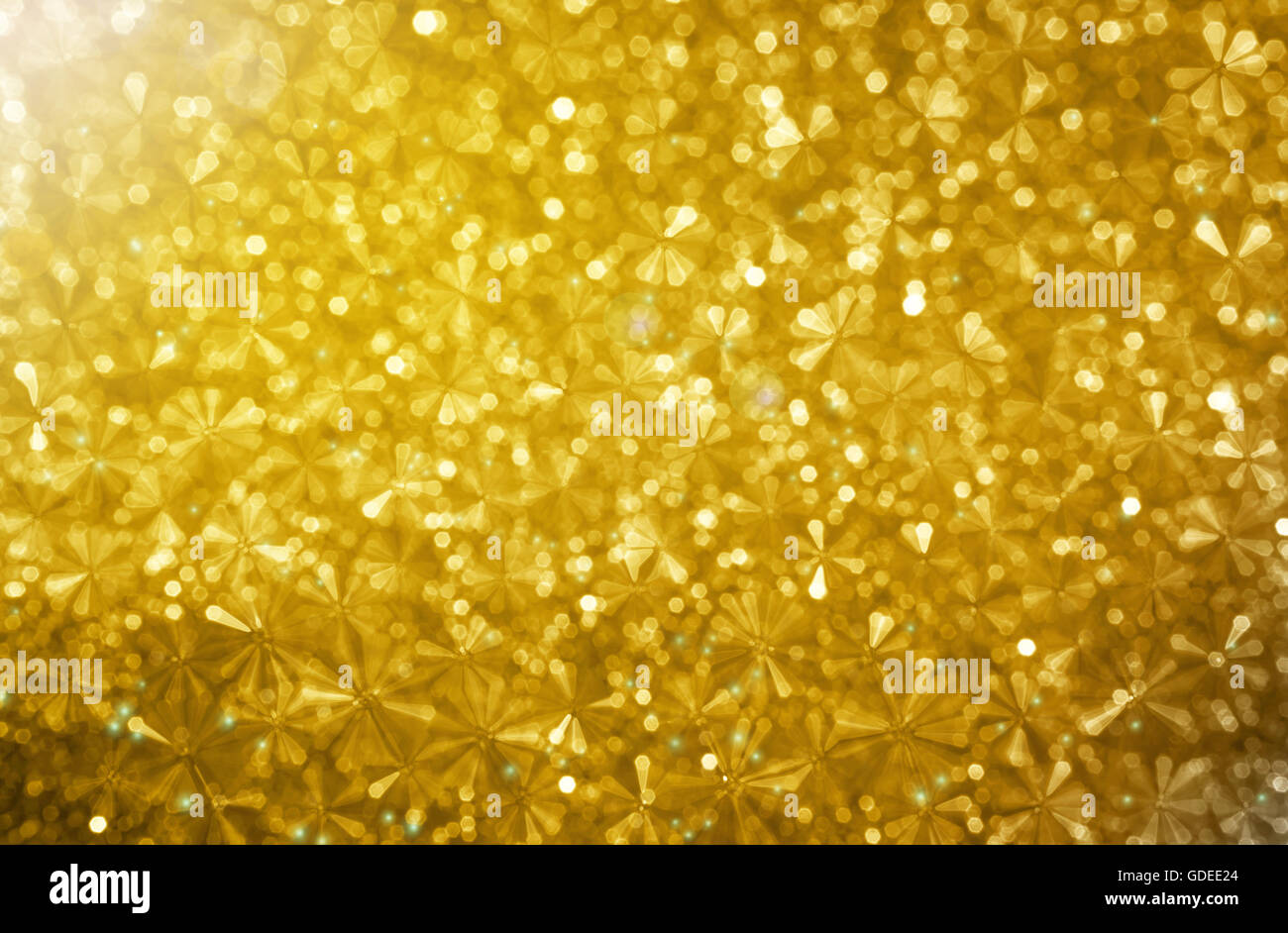 Abstract small flower shape in glow golden bokeh light background, dreamy sparkle glittery wonderful and luxury background Stock Photo