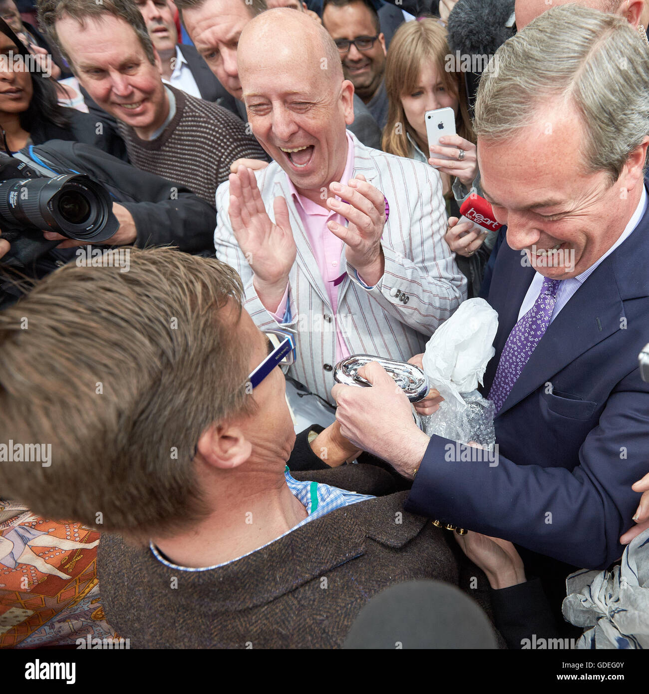 Nigel Farage (R), UKIP party leader receives a gift from a supporter during a campaign visit to Aylesbury Stock Photo
