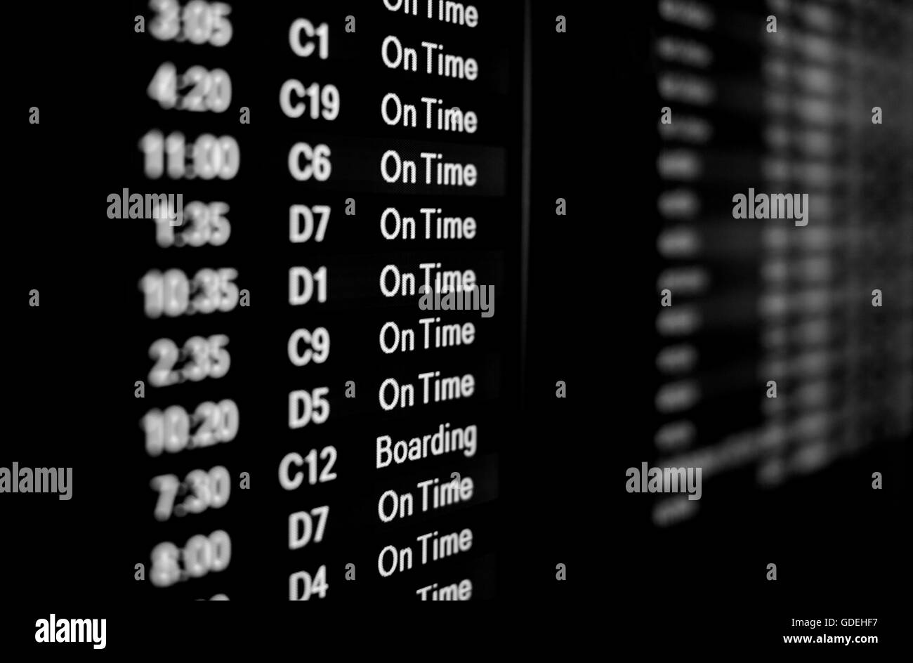 Close up of airline flight monitor showing gate and departure time with shallow depth of field Stock Photo