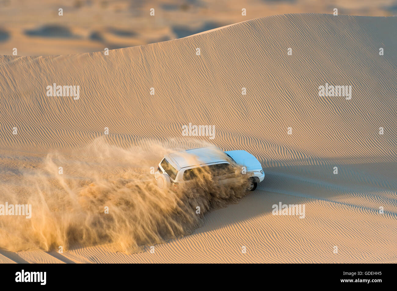 Off road vehicle driving through desert, Abu Dhabi, UAE Stock Photo