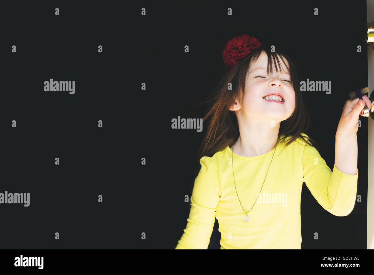 Portrait of smiling girl standing in doorway Stock Photo - Alamy