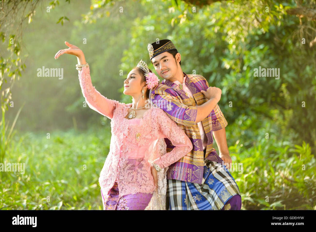 Man and woman in traditional clothing dancing, Asia Stock Photo