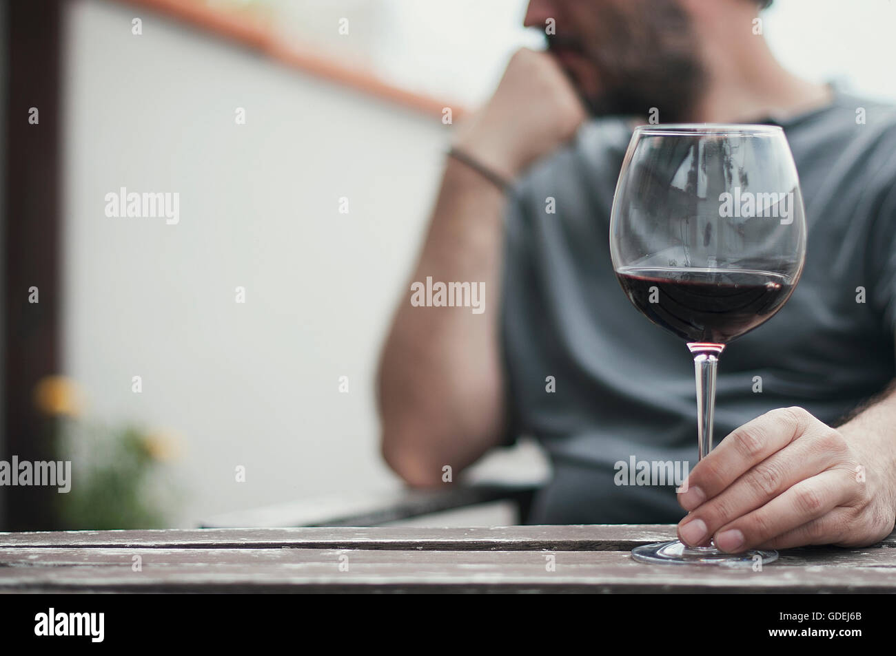 Man sitting with glass of red wine Stock Photo - Alamy
