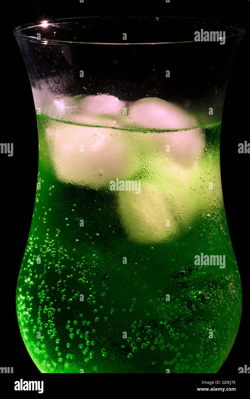 Glass of green lemonade with ice cubes Stock Photo