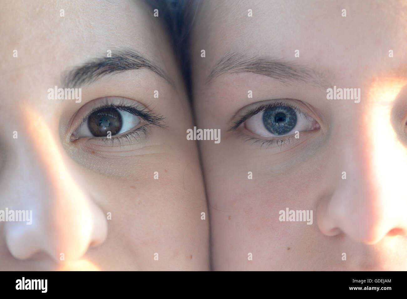 Close-up of woman and girl's faces side by side Stock Photo
