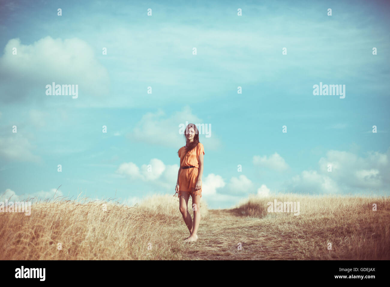 Woman standing in field Stock Photo - Alamy