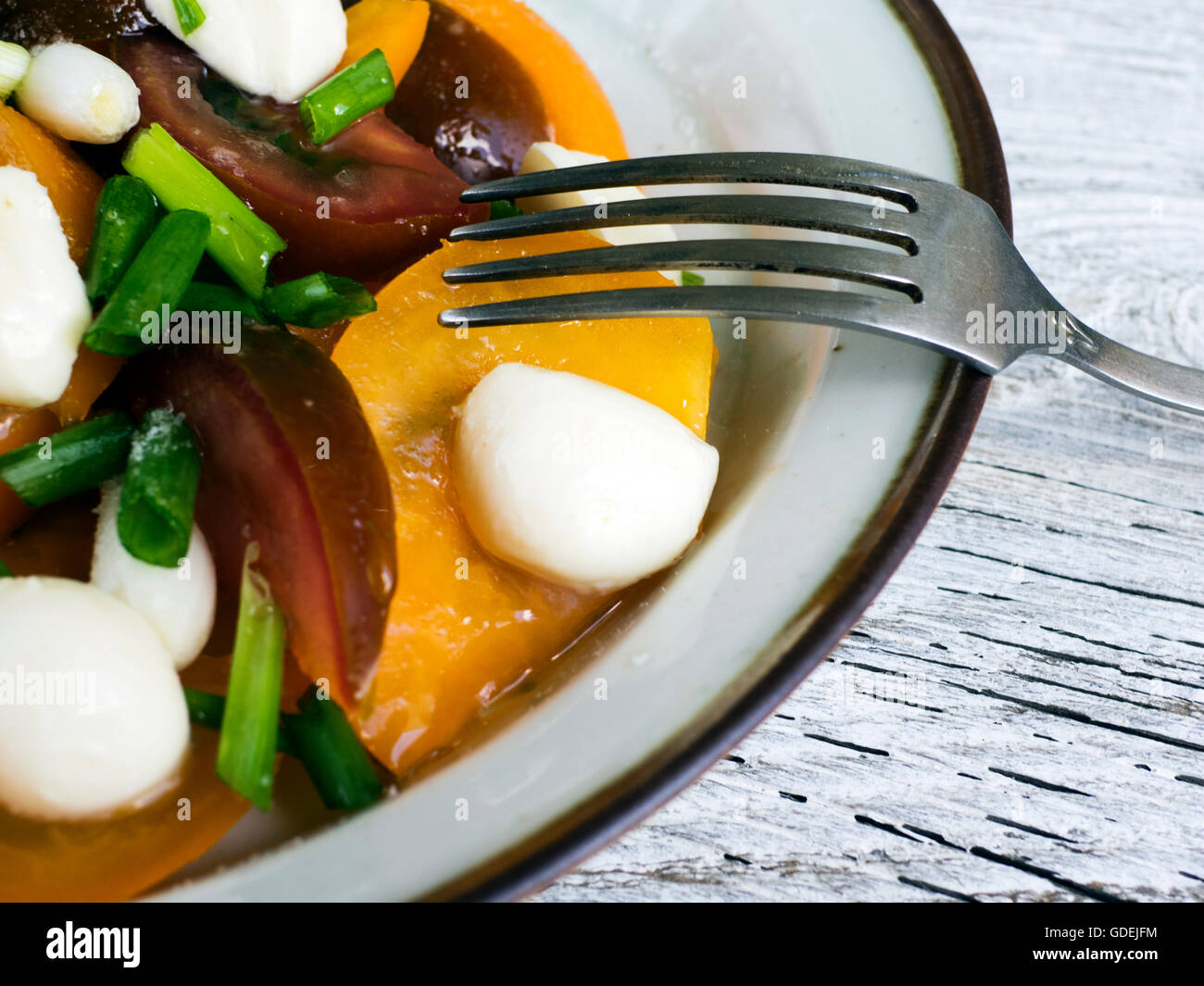 black and yellow tomato salad with spring onion and goats cheese Stock Photo