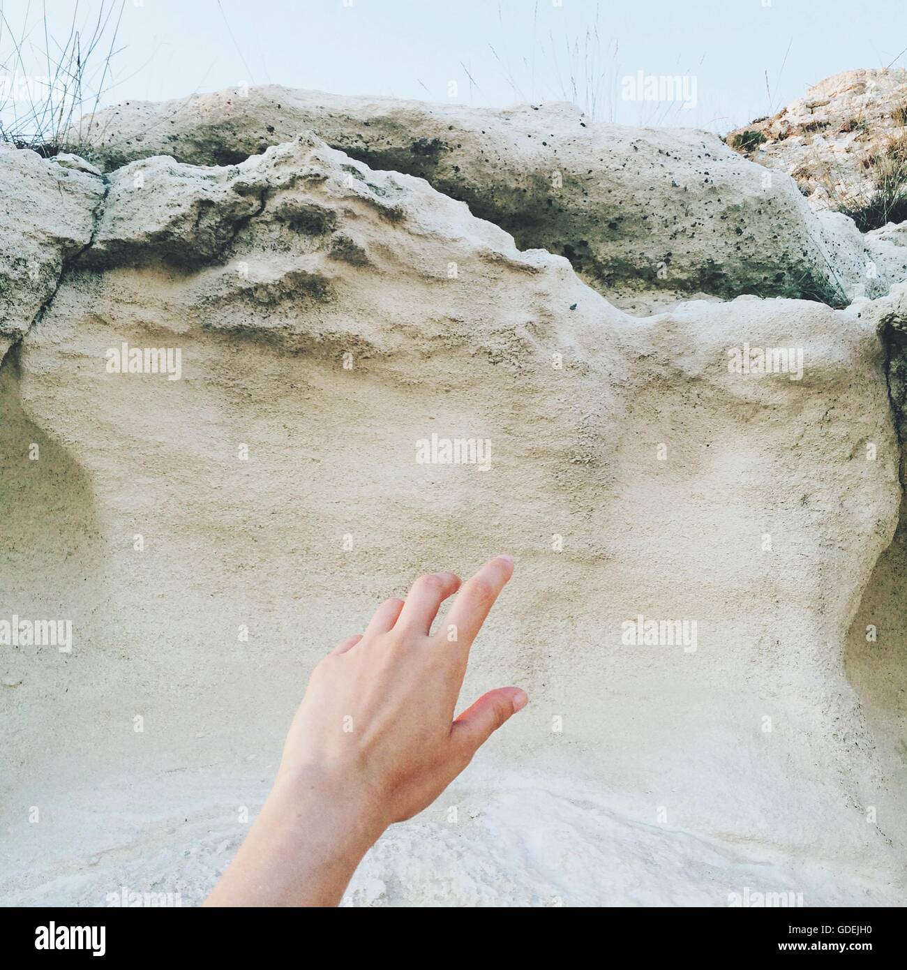 Hand reaching rocks hi-res stock photography and images - Alamy