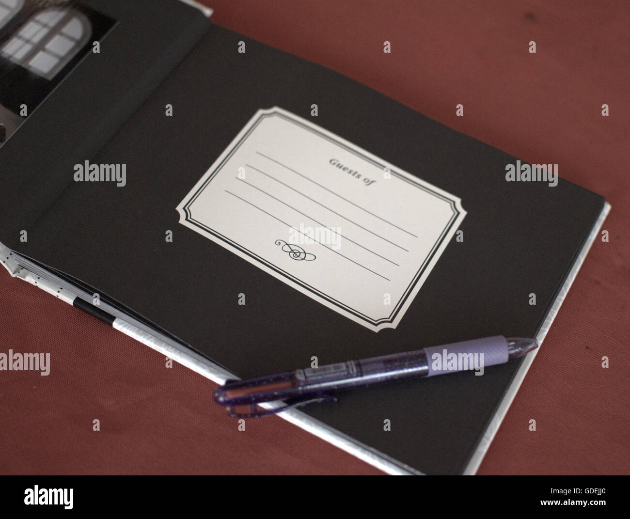 Visitors book and pen on table Stock Photo Alamy