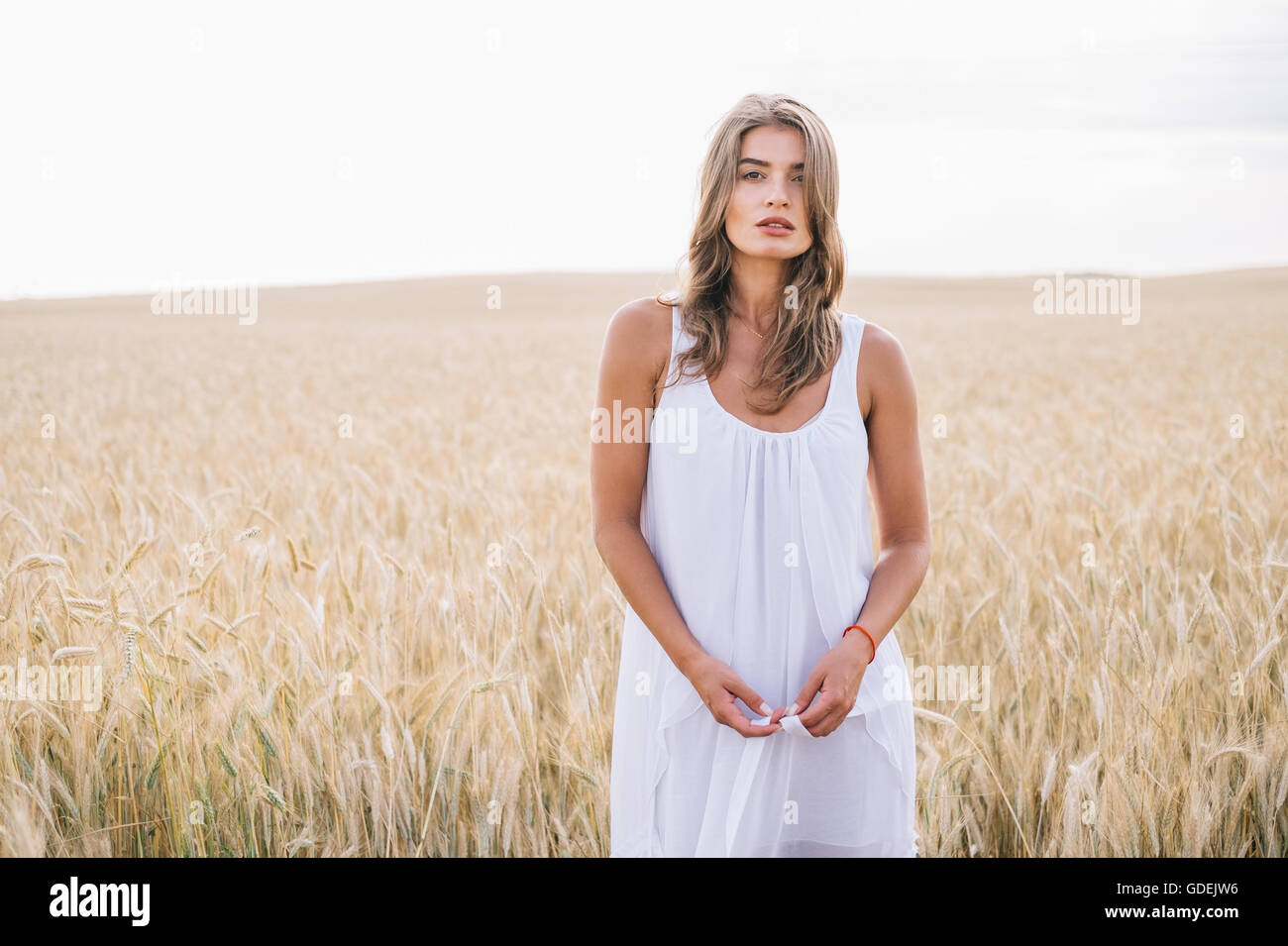 Portrait of a woman standing in wheat field Stock Photo - Alamy
