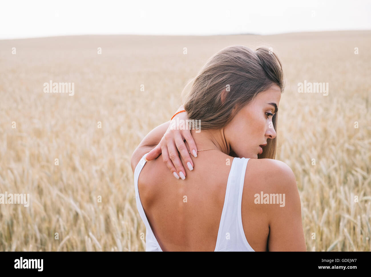 Woman standing in wheat field Stock Photo