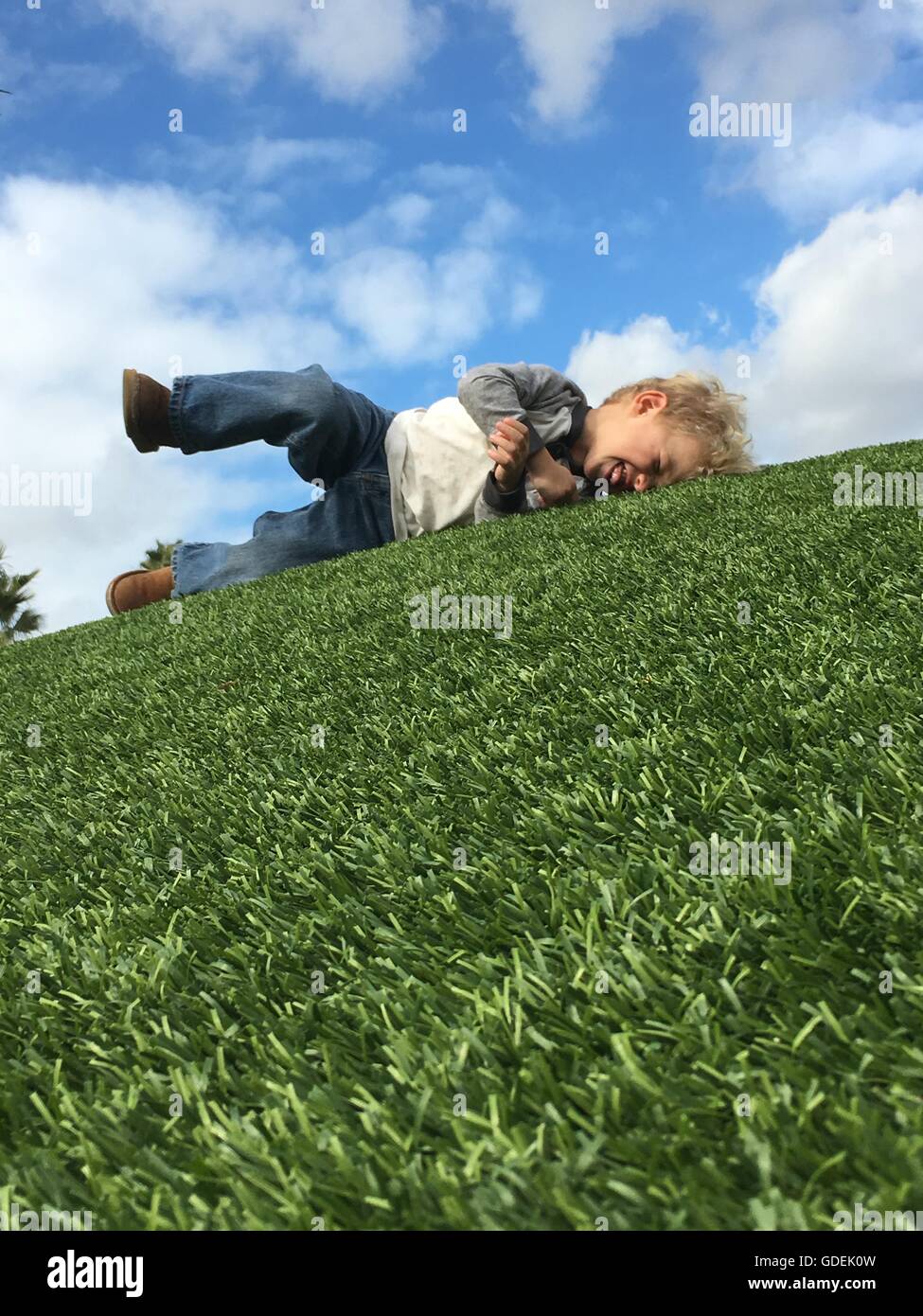 Boy rolling around on grass hires stock photography and images Alamy