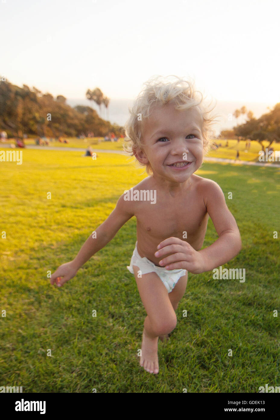 Boy running in park Stock Photo