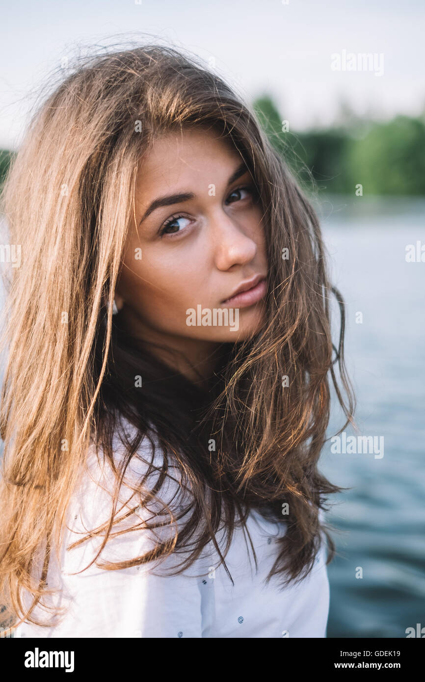 Portrait of a woman looking over shoulder Stock Photo