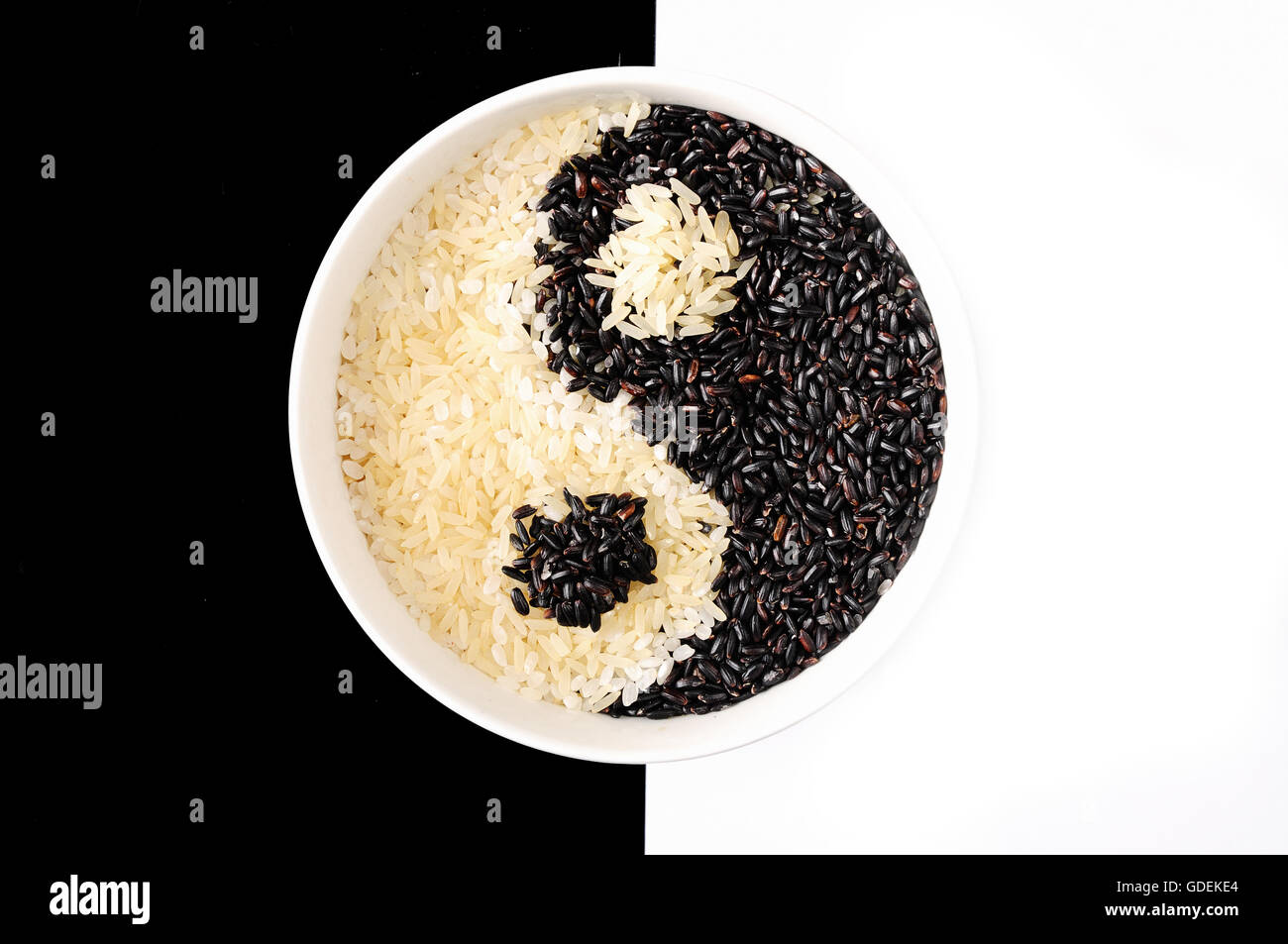 Black and white rice forming a yin yang symbol Stock Photo