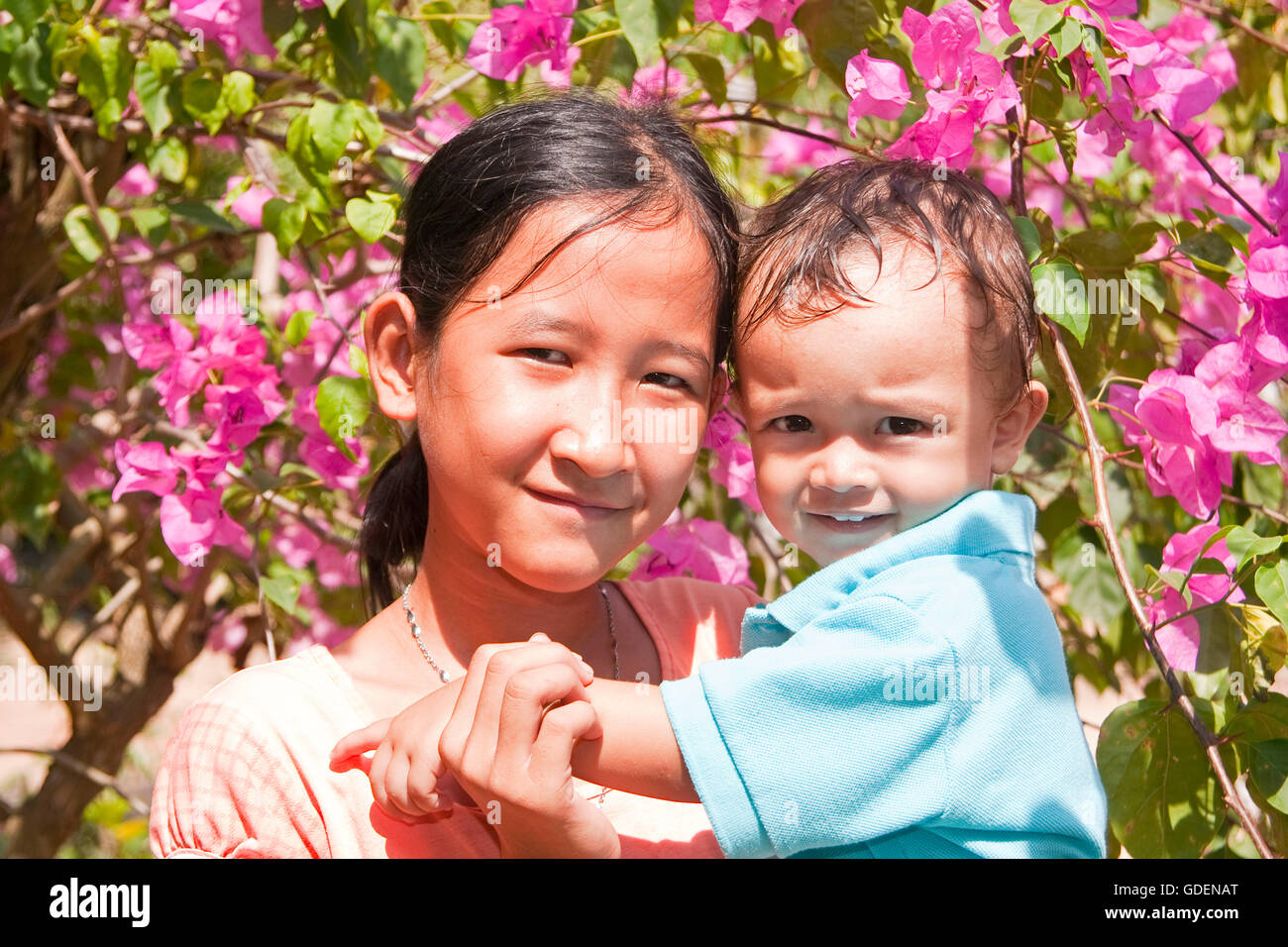 Girl with little boy, Phu Quoc island, Vietnam Stock Photo