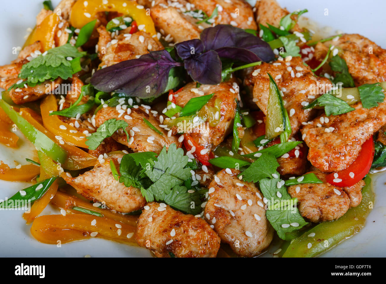 Stir-fried chicken with vegetables and herbs Stock Photo - Alamy