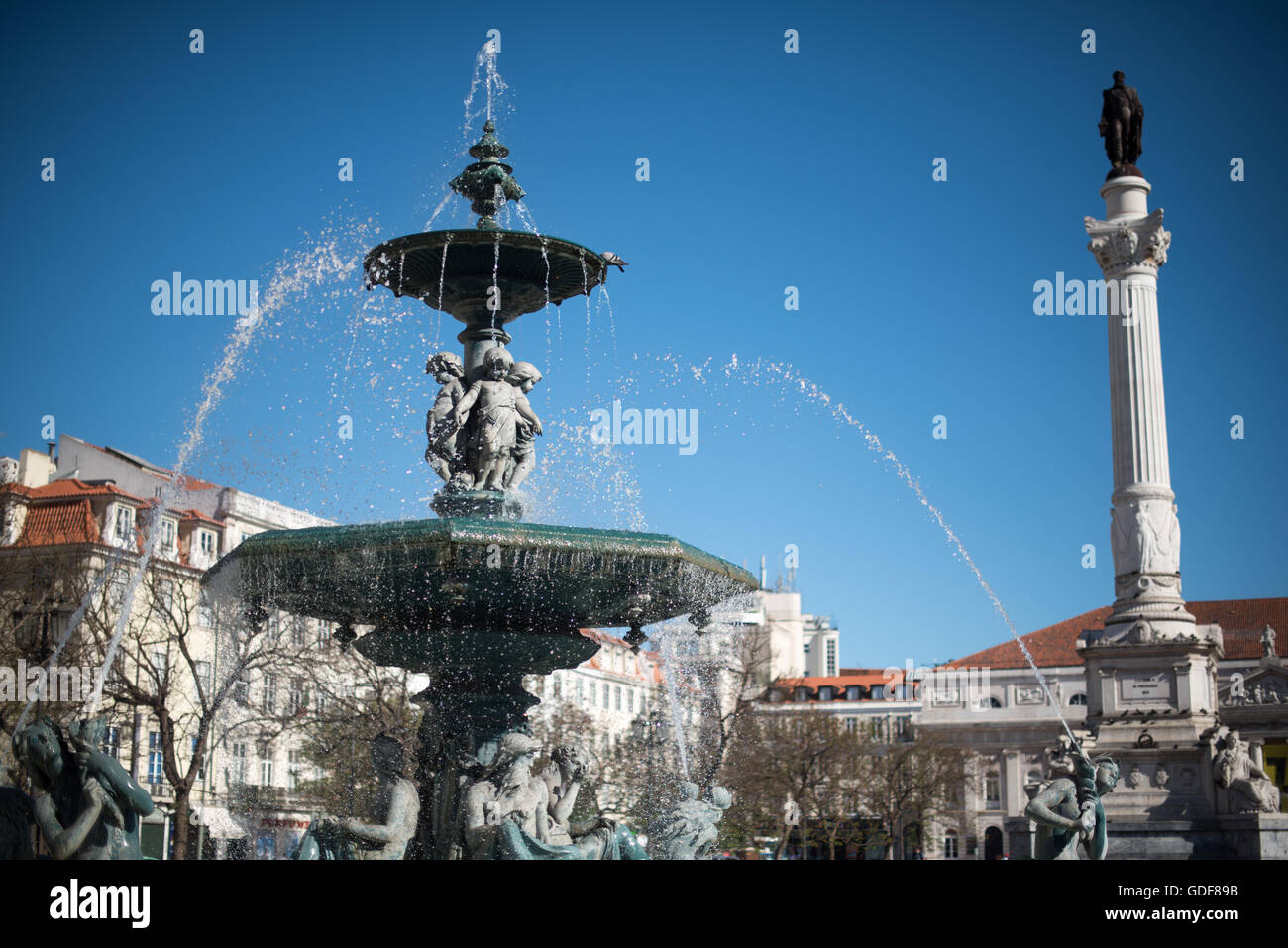 LISBON, Portugal - Formally known as Pedro IV Square (or Praça de D. Pedro IV in Portuguese), Rossio Square has been a vibrant public commons in Lisbon for centuries. At its center stands a column topped with a statue of King Pedro IV (Peter IV; 1798-1834) that was erected in 1870. Stock Photo