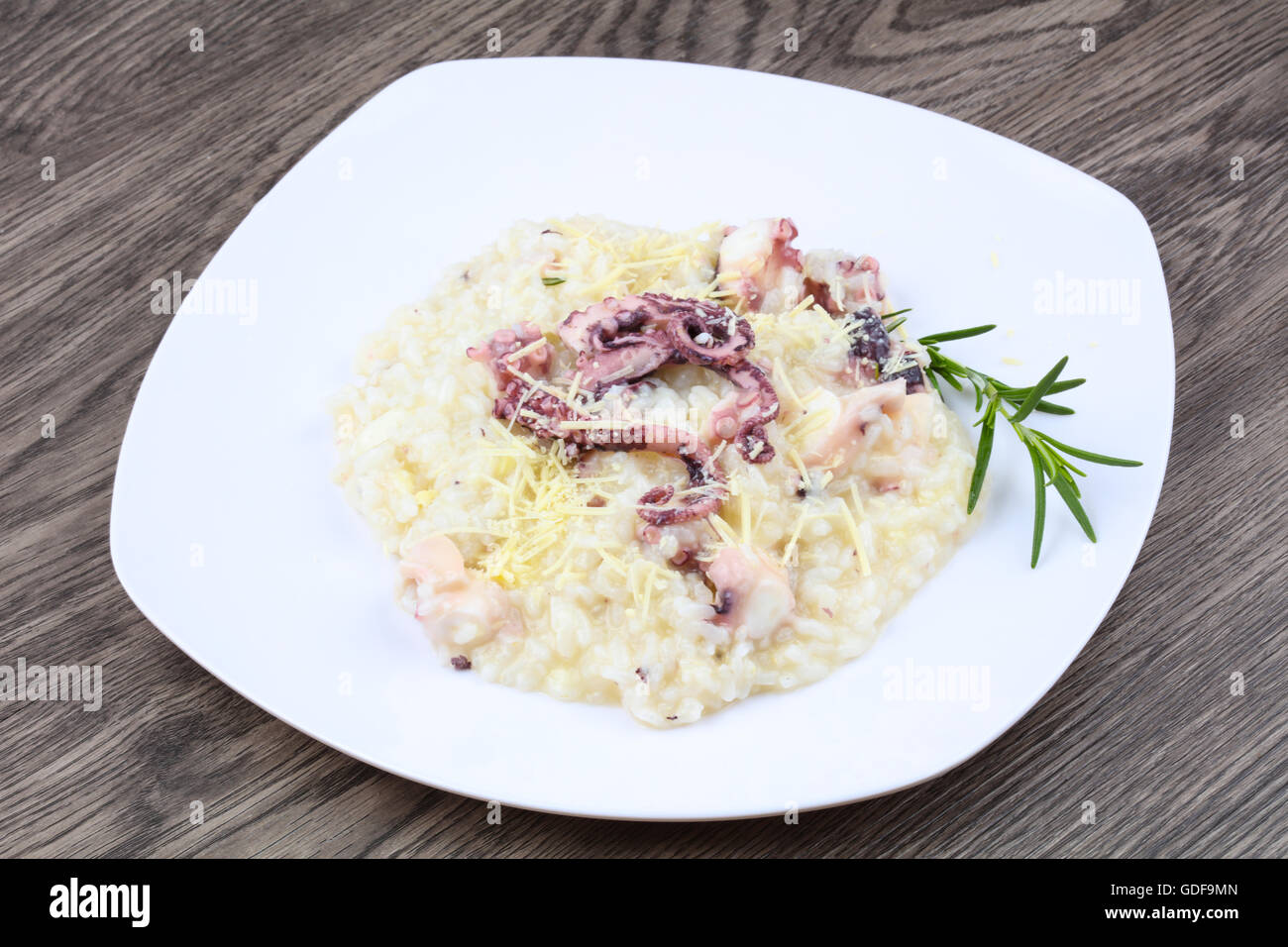 Risotto with octopus served green rosemary Stock Photo - Alamy