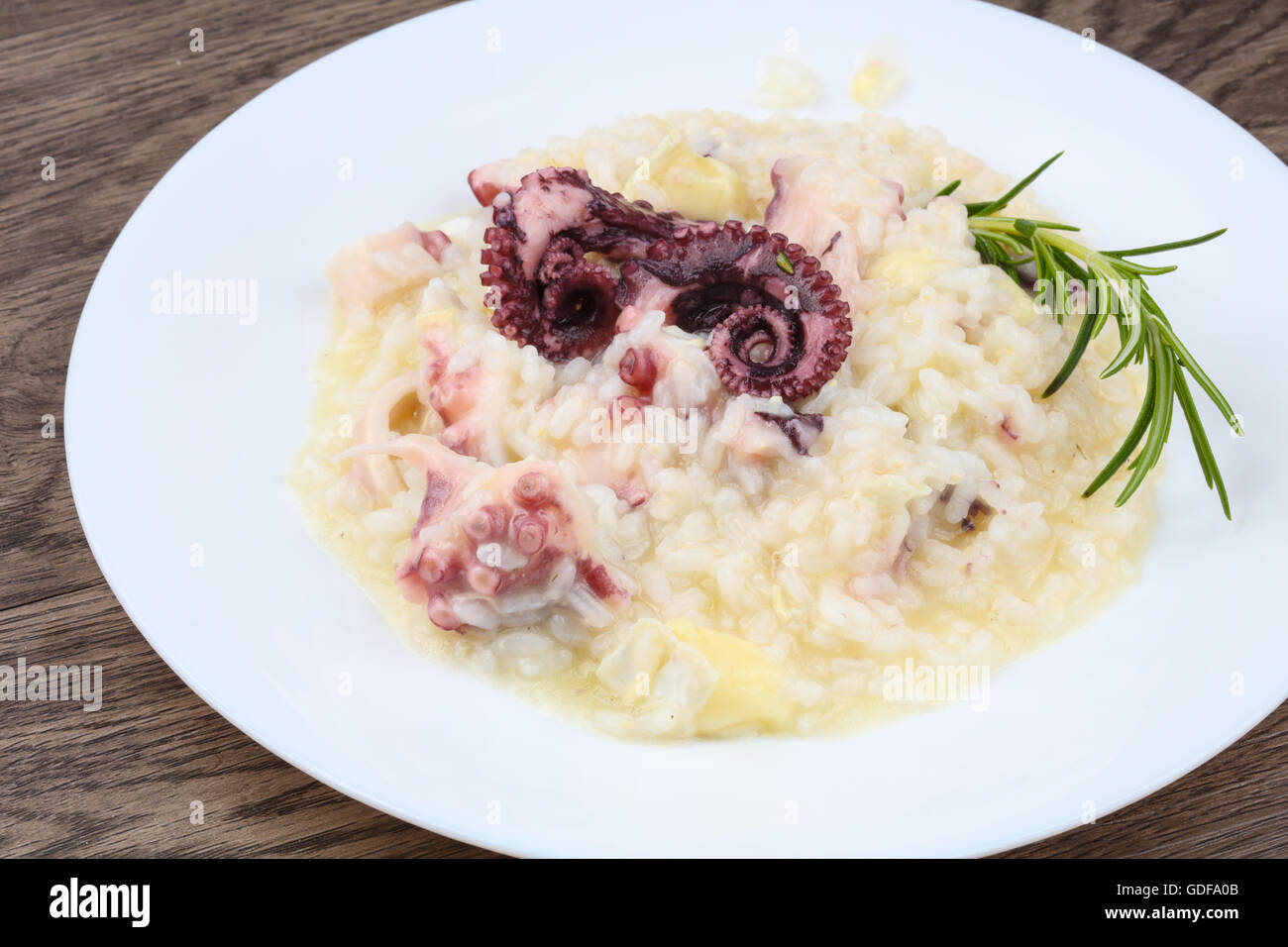 Risotto with octopus served green rosemary Stock Photo Alamy