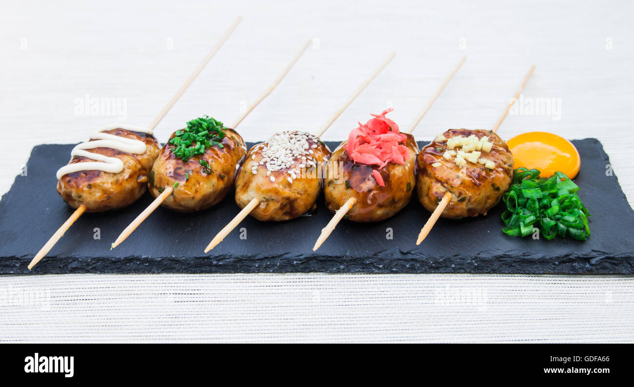 Tsukune Japanese chicken yakitori meatballs served with chili sauce