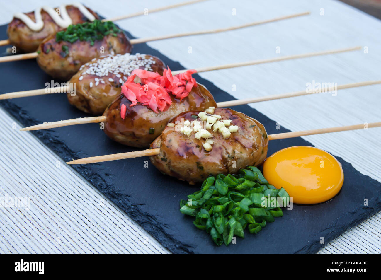 Tsukune Japanese chicken yakitori meatballs served with chili sauce